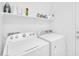 Efficient laundry room with a washer and dryer, ample storage, and bright lighting at 16887 W Belleview St, Goodyear, AZ 85338