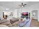 Spacious living room featuring a large sectional sofa, neutral color palette, and entertainment center at 16887 W Belleview St, Goodyear, AZ 85338