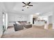 Open concept living room with tile flooring, a plush couch and natural light at 16887 W Belleview St, Goodyear, AZ 85338