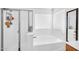 Modern bathroom with a glass enclosed shower, soaking tub, and dual sinks at 16887 W Belleview St, Goodyear, AZ 85338