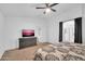 Comfortable bedroom with a TV, dresser, and attached bathroom with separate shower at 16887 W Belleview St, Goodyear, AZ 85338