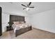 Primary bedroom features a comfortable king-size bed and a ceiling fan at 16887 W Belleview St, Goodyear, AZ 85338