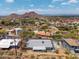 Aerial view of home nestled in desert landscape with mountain backdrop at 1701 E Camino Del Santo --, Phoenix, AZ 85022