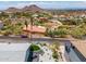 Aerial view showcases the home with desert landscaping, patio, and mountain views at 1701 E Camino Del Santo --, Phoenix, AZ 85022