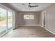 Bedroom boasts natural light from slider, tile flooring, and neutral paint scheme at 1701 E Camino Del Santo --, Phoenix, AZ 85022