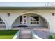 Elegant arched home entrance with tiled stairs, desert landscaping at 1701 E Camino Del Santo --, Phoenix, AZ 85022