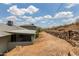 Exterior view of home and dirt yard with rock wall at 1701 E Camino Del Santo --, Phoenix, AZ 85022