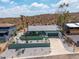 This aerial view captures an updated home with desert landscaping, mature palms, and a wide driveway at 1701 E Camino Del Santo --, Phoenix, AZ 85022