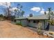 Rear exterior view of home, showcasing desert landscaping and access to patio at 1701 E Camino Del Santo --, Phoenix, AZ 85022