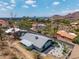 An aerial view shows an updated home featuring desert landscaping on a sloped lot with neighborhood views at 1701 E Camino Del Santo --, Phoenix, AZ 85022