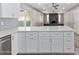 Modern kitchen features new stainless appliances, white cabinetry, and is open to the living room at 1701 E Camino Del Santo --, Phoenix, AZ 85022