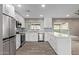 Modern kitchen features new stainless appliances, white cabinetry, and a peninsula island at 1701 E Camino Del Santo --, Phoenix, AZ 85022
