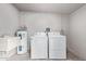 Laundry room featuring a washer, dryer, utility sink, and brick walls at 1701 E Camino Del Santo --, Phoenix, AZ 85022