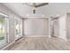 Bright living room boasts a ceiling fan, outside views, and wood-look tile flooring at 1701 E Camino Del Santo --, Phoenix, AZ 85022