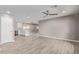 Spacious open-concept living room with tile floors and modern ceiling fan at 1701 E Camino Del Santo --, Phoenix, AZ 85022