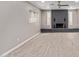 Living room features a sleek gray brick fireplace, hardwood floors, and recessed lighting at 1701 E Camino Del Santo --, Phoenix, AZ 85022