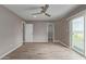 Main bedroom boasts natural light from slider, tile flooring, and neutral paint scheme at 1701 E Camino Del Santo --, Phoenix, AZ 85022