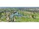 Beautiful aerial view of golf course featuring waterways and lush landscaping surrounded by palm trees and city scenery at 1814 W Thomas Rd, Phoenix, AZ 85015