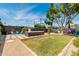 Landscaped backyard featuring a swim spa, gravel, stone, a grass lawn, and Adirondack chairs for a relaxing outdoor experience at 1814 W Thomas Rd, Phoenix, AZ 85015