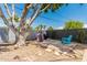 The backyard is designed with a patio, a barbecue grill, a heater, and a shade tree for perfect outdoor living at 1814 W Thomas Rd, Phoenix, AZ 85015