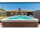 Backyard swimming pool with seating area with view of house at 1814 W Thomas Rd, Phoenix, AZ 85015