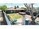 This landscaped backyard features a swim spa, lawn, patio, trees, and lounge seating, perfect for relaxation and entertainment at 1814 W Thomas Rd, Phoenix, AZ 85015