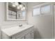 Well-lit bathroom features a white vanity and a modern light fixture at 1814 W Thomas Rd, Phoenix, AZ 85015