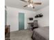 Bedroom featuring a ceiling fan, snowboard, and office setup at 1814 W Thomas Rd, Phoenix, AZ 85015