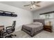 Bedroom featuring a comfortable bed, side table, and a desk with a chair at 1814 W Thomas Rd, Phoenix, AZ 85015
