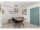 Bright dining room with modern light fixture, wooden table and comfortable seating at 1814 W Thomas Rd, Phoenix, AZ 85015