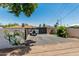 Home's expansive driveway features a two-car garage and a brick privacy wall with a floral design at 1814 W Thomas Rd, Phoenix, AZ 85015