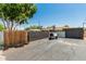 Long driveway leading to a two-car garage, with a gated fence to secure the property at 1814 W Thomas Rd, Phoenix, AZ 85015