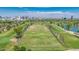 Scenic aerial view of the driving range with downtown skyline in the distance, surrounded by lush greenery at 1814 W Thomas Rd, Phoenix, AZ 85015