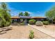 Home featuring a neat front yard, solar panels, and a walkway to the front door at 1814 W Thomas Rd, Phoenix, AZ 85015