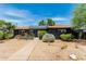 Lovely home featuring a neat front yard, solar panels, and a walkway to the front door at 1814 W Thomas Rd, Phoenix, AZ 85015