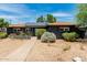 Beautiful home featuring a neat front yard, solar panels, and a walkway to the front door at 1814 W Thomas Rd, Phoenix, AZ 85015