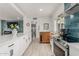 Bright kitchen featuring modern appliances, white cabinets, and ample countertop space at 1814 W Thomas Rd, Phoenix, AZ 85015