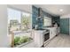 Stylish kitchen with modern appliances, blue backsplash, and ample natural light at 1814 W Thomas Rd, Phoenix, AZ 85015