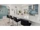 Spacious kitchen with modern white countertops, breakfast bar seating, and stainless steel appliances at 1814 W Thomas Rd, Phoenix, AZ 85015