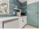 Modern kitchen features built-in microwave and dishwasher with a stylish teal door at 1814 W Thomas Rd, Phoenix, AZ 85015