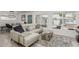 Bright living room with white sofa, plush rug, and a view to the backyard at 1814 W Thomas Rd, Phoenix, AZ 85015