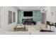 Stylish living room featuring a scooter bar, a large TV, and elegant white furniture at 1814 W Thomas Rd, Phoenix, AZ 85015