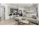 Open living room flowing to kitchen, with sleek breakfast bar, white sofa and stylish decor at 1814 W Thomas Rd, Phoenix, AZ 85015