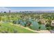 Picturesque aerial view of a lake with lush landscaping, towering trees, and a view of the city skyline at 1814 W Thomas Rd, Phoenix, AZ 85015