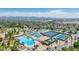 Comprehensive aerial showcasing pool, tennis courts, and recreation areas, with a backdrop of mountains at 1814 W Thomas Rd, Phoenix, AZ 85015