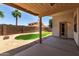 Covered patio overlooks backyard featuring grass, desert landscaping and block wall at 18899 N 77Th Ave, Glendale, AZ 85308