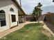 Backyard with grass, desert landscaping, and covered patio, perfect for outdoor living at 18899 N 77Th Ave, Glendale, AZ 85308