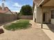 This backyard features a small patch of grass surrounded by gravel and a block wall at 18899 N 77Th Ave, Glendale, AZ 85308