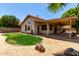 Spacious backyard featuring low maintenance desert landscaping with stucco home, and covered patio for outdoor relaxation at 18899 N 77Th Ave, Glendale, AZ 85308