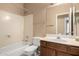 Bathroom featuring a bathtub with shower, toilet, sink, and mirror at 18899 N 77Th Ave, Glendale, AZ 85308